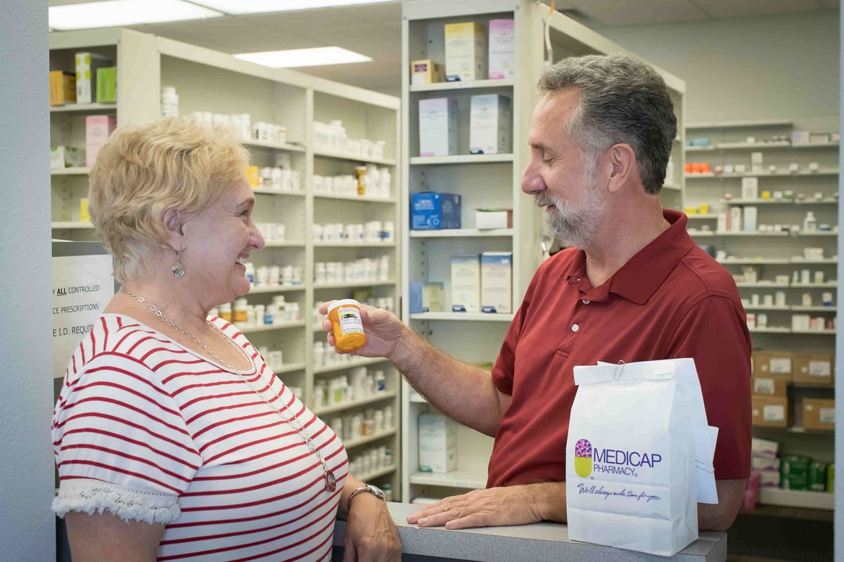 Pharmacist reviewing medications with a patient